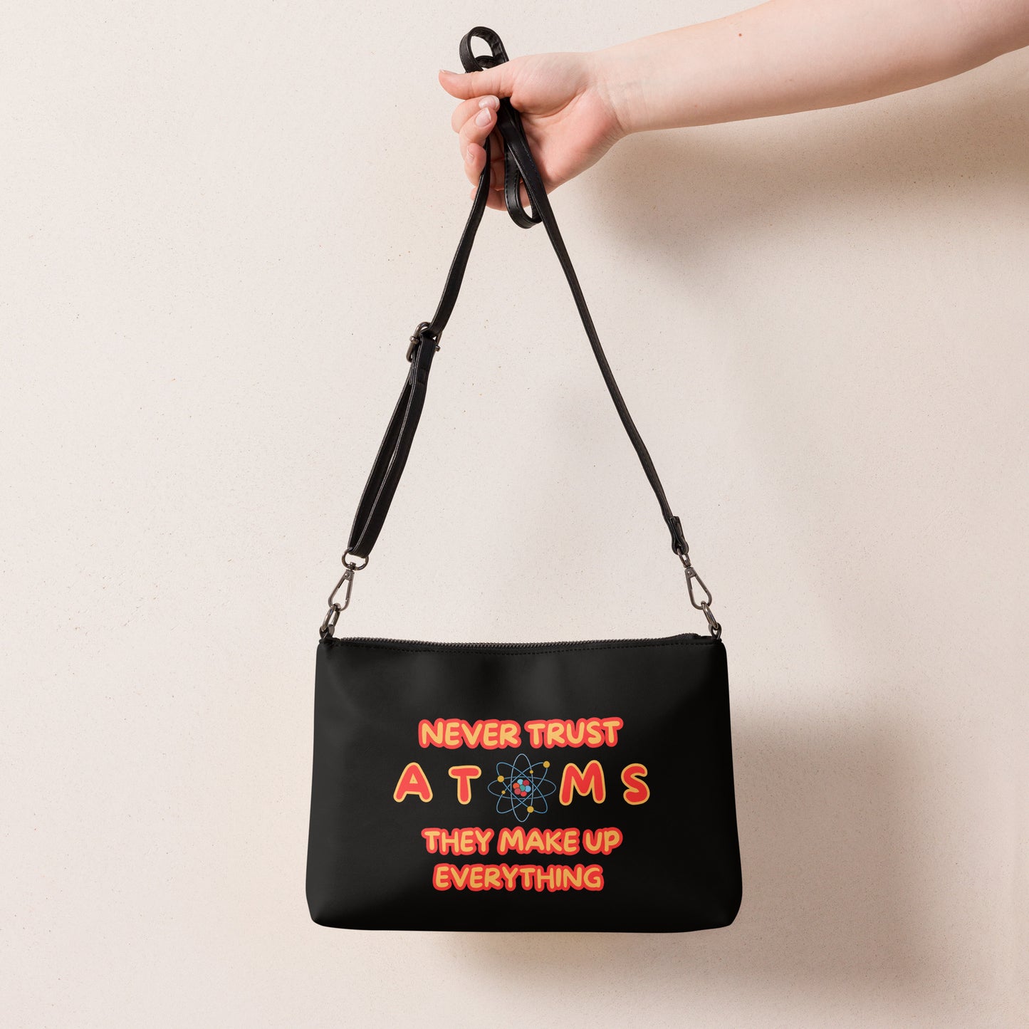 Never Trust Atoms They Make Up Everything Crossbody bag